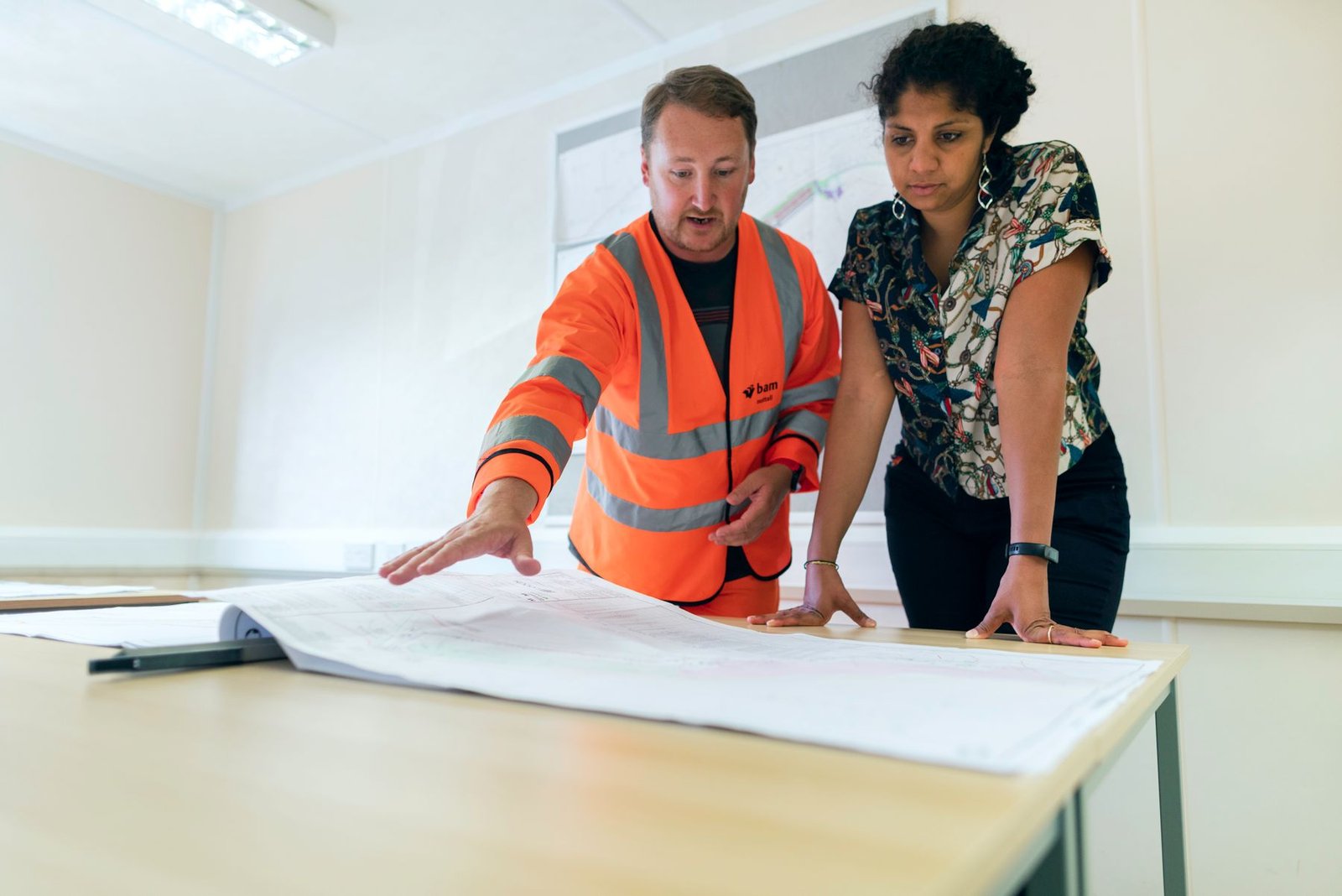 Engineering team reviewing project drawings